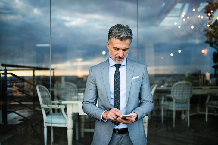 Businessman Checks Phone